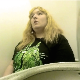 A fat, blonde girl records herself using an airplane toilet. There is a lot of background noise, but we can see her pushing, straining, and wiping. Presented in 720P HD. About 3 minutes.